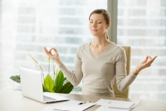 Calm businesswoman relaxing with breath gymnastics